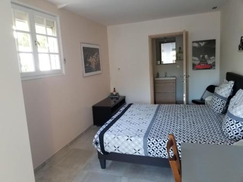 a bedroom with a bed and a sink in it at Les Lauriers in Espondeilhan