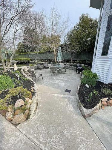 a patio with benches and tables in a yard at Libby's Cove in Carsonville