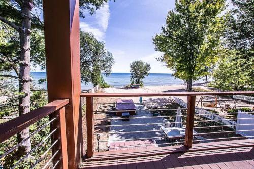a porch with a view of the beach and the ocean at Libby's Cove in Carsonville