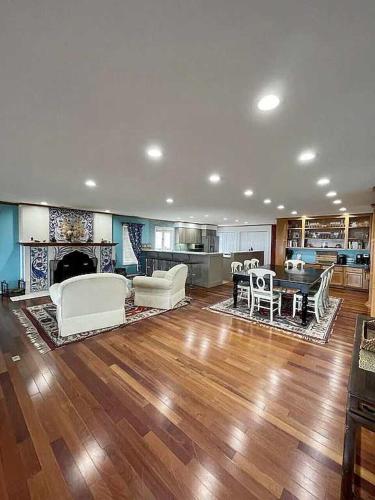 a large living room with white furniture and a kitchen at Libby's Cove in Carsonville