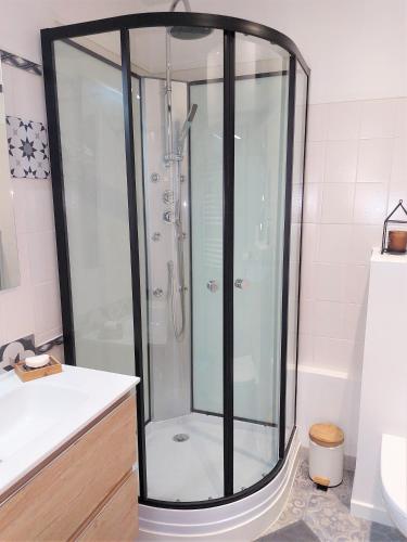 a shower with a glass enclosure in a bathroom at L'Escale Centre Historique de Gap Meublé de tourisme Classé 3 étoiles in Gap