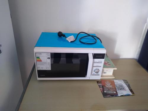 a microwave with a blue top sitting on a table at Cuesta de san miguel in Chilecito