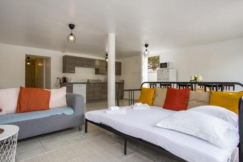 un salon avec un canapé et une cuisine dans l'établissement Appartement Canari - Bayonne - Welkeys, à Bayonne