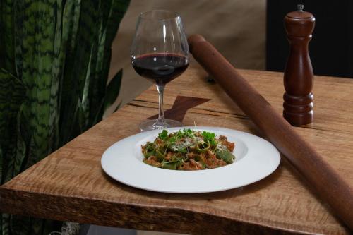 a plate of food and a glass of wine on a table at Toll House Hotel Los Gatos in Los Gatos
