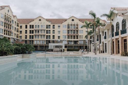 a large swimming pool in front of a building at Work-friendly Mountain-view condo near SM Seaside in Cebu City