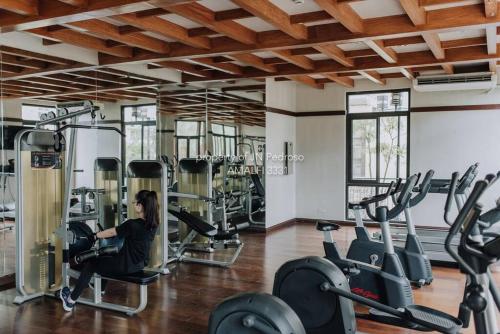 a woman exercising in a gym with tread machines at Work-friendly Mountain-view condo near SM Seaside in Cebu City