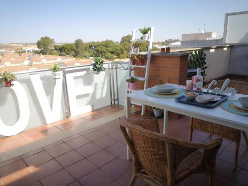 a table and chairs on a balcony with a view at Ático Love in Jerez de la Frontera