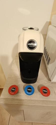 a toaster sitting on top of a counter with four stickers at Appartamento Beatrice in Villanova dʼAsti