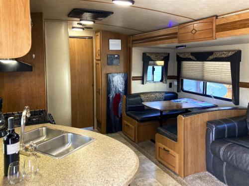 an rv kitchen with a sink and a table at H - Poop Deck in Fort Bragg