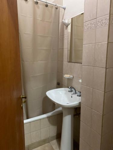 a bathroom with a sink and a shower with a mirror at Complejo Las Moras in Santa Rosa