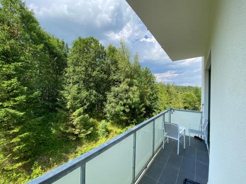 a balcony with a view of trees at Apartmány Veternica v Bernarde in Smokovce