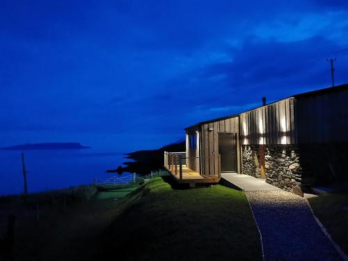 a building with a door on the side of it at Byre 7 Aird of Sleat in Aird of Sleat