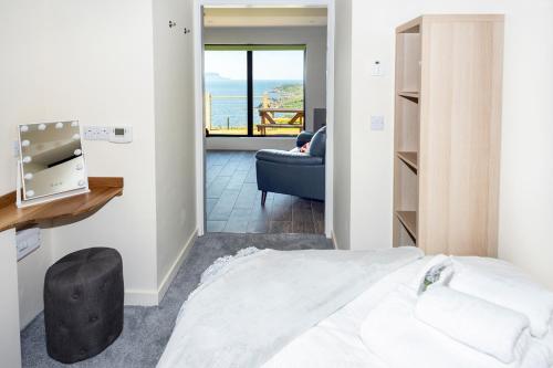 a bedroom with a bed and a view of the ocean at Byre 7 Aird of Sleat in Aird of Sleat