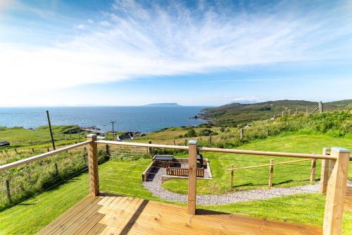 a wooden deck with a view of the ocean at Byre 7 Aird of Sleat in Aird of Sleat