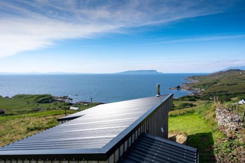 a roof of a house with a view of the ocean at Byre 7 Aird of Sleat in Aird of Sleat