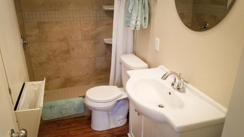 a bathroom with a sink and a toilet and a shower at HA Whitney Inn in Columbus