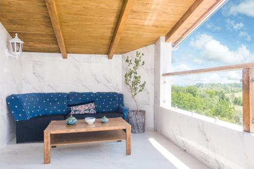 a living room with a blue couch and a table at Irina in Soko Banja