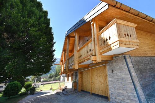 a wooden building with a balcony on top of it at Apartment Marent Garten Chalet in Vandans