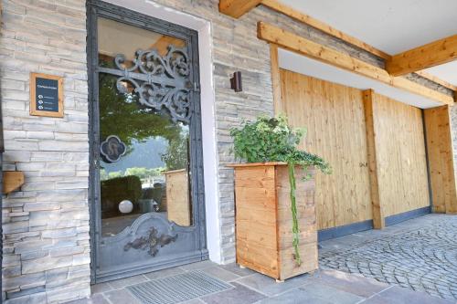 an entry door to a house with a potted plant at Apartment Marent Garten Chalet in Vandans