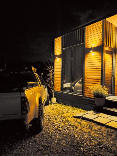 a truck parked in front of a house at night at Stablo guest house in Bărăşti