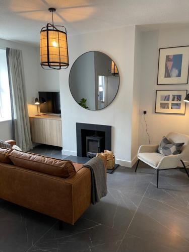 a living room with a couch and a mirror at The Village House in Malahide