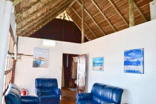 two blue leather chairs in a room with a ceiling at Mozambique,Inhambane,Barra -Entire Beach House in Inhambane