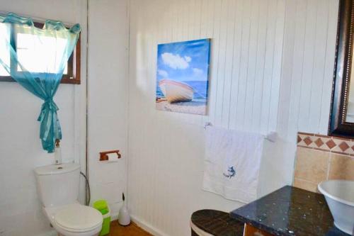 y baño con aseo blanco y lavamanos. en Mozambique,Inhambane,Barra -Entire Beach House, en Inhambane
