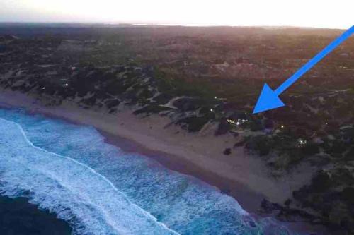 an aerial view of a beach with a blue arrow at Mozambique,Inhambane,Barra -Entire Beach House in Inhambane