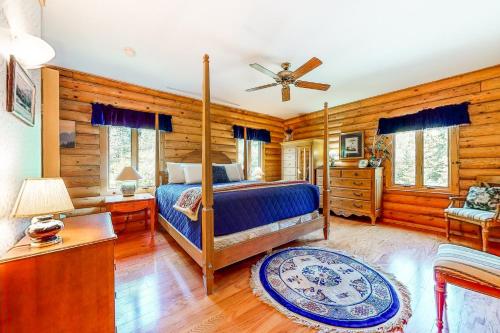 a bedroom with a bed and a ceiling fan at White Mountain Log Home in Carroll