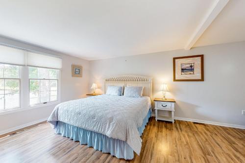 a bedroom with a bed and two night stands at Peaceful Pintail in Ocean Pines