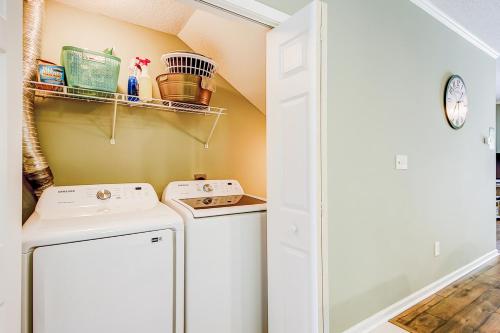 a small laundry room with a washer and dryer at Albatross in Little River