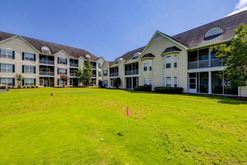 a golf course in front of a large building at Albatross in Little River