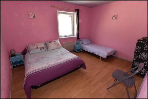 a bedroom with pink walls and a bed and a window at Doudou Vercors in Lans-en-Vercors