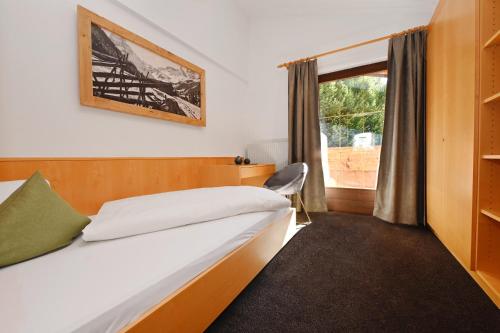 a bedroom with a bed and a window at Apartment Marent Garten Chalet in Vandans