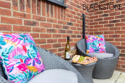 a table with a bottle of wine and a glass at Island House - 3 Bedroom Townhouse by BPNE in Darlington