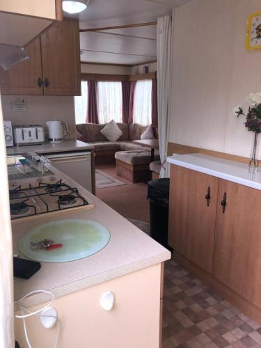 a kitchen with a stove and a counter top at Fantasy Island 6 Berth 576 in Ingoldmells