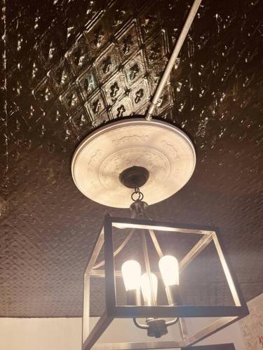 a chandelier hanging from the ceiling in a room at 1850s historic Row House 7min train to NYC with private backyard in Jersey City