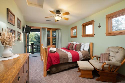 a bedroom with a bed and a chair at Adventures From Bozeman's Perfect Location in Bozeman