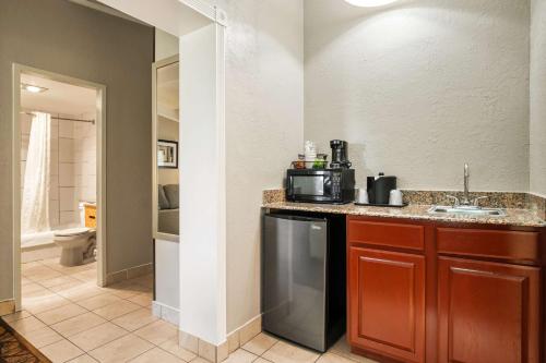 a kitchen with a sink and a counter with a microwave at Best Western Hospitality Hotel & Suites in Cascade