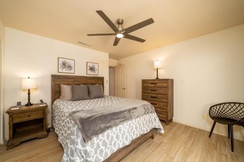 a bedroom with a bed and a ceiling fan at Grand Havasu Oasis with Custom Pool & Spa! in Lake Havasu City