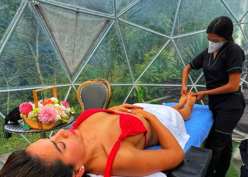 a woman getting a massage in a greenhouse at Yuva Glamping in San Francisco