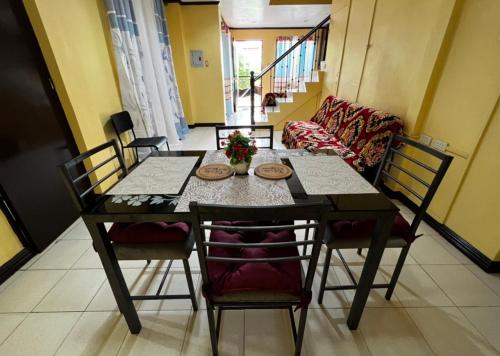 a dining table and chairs in a living room at House to rent in a Gated Community with 24hr Security 