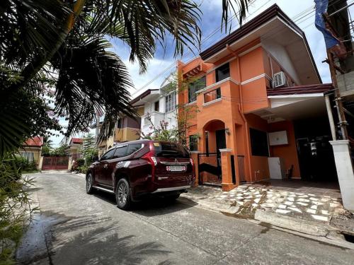 a red car parked in front of a building at House to rent in a Gated Community with 24hr Security in Lawa-an