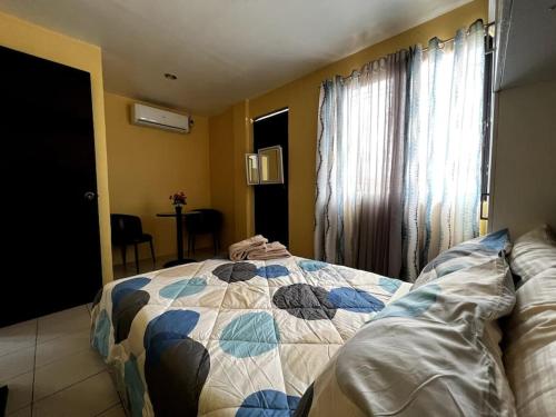 a bedroom with a bed with a quilt on it at House to rent in a Gated Community with 24hr Security in Lawa-an