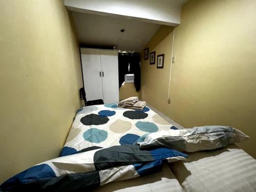 a bedroom with a bed with a comforter on it at House to rent in a Gated Community with 24hr Security in Lawa-an