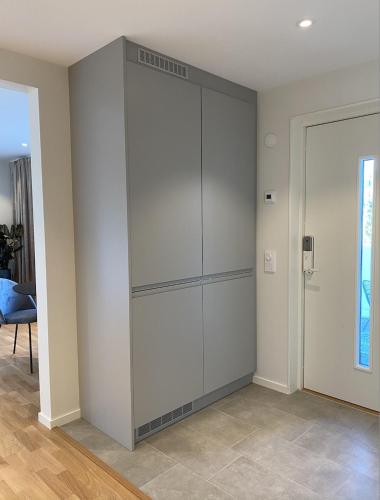 a large white cabinet in the corner of a room at Luxurious villa with free parking in Gothenburg