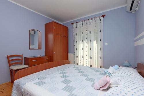 a bedroom with a bed with a pink towel on it at Double Room Vrbnik 5299c in Vrbnik
