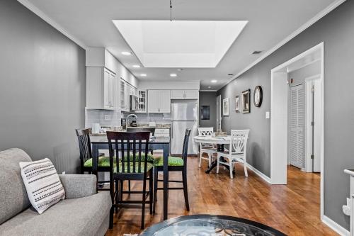a kitchen and living room with a couch and a table at Dunescape Villas 346 in Atlantic Beach