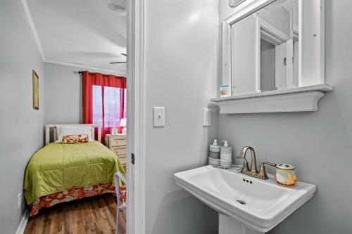 a bathroom with a sink and a bed in a room at Dunescape Villas 346 in Atlantic Beach
