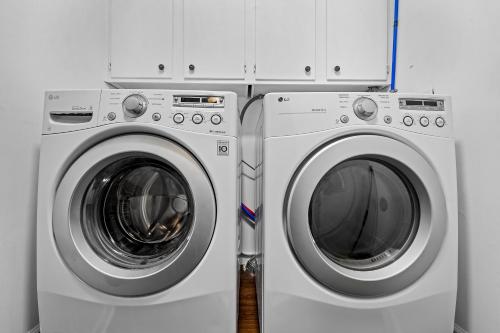 a washing machine and a dryer in a room at Dunescape Villas 346 in Atlantic Beach